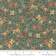 The image is a fabric with a floral pattern, featuring various shades of green, orange, and yellow flowers and leaves. The fabric appears to be a textile or material with a repeating floral design.