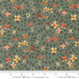 The image is a fabric with a floral pattern, featuring various shades of green, orange, and yellow flowers and leaves. The fabric appears to be a textile or material with a repeating floral design.