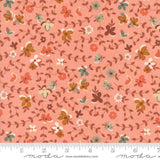 The image is a fabric with a floral pattern in shades of pink and orange. The pattern consists of various flowers and leaves in different colors, creating a visually appealing and textured design.