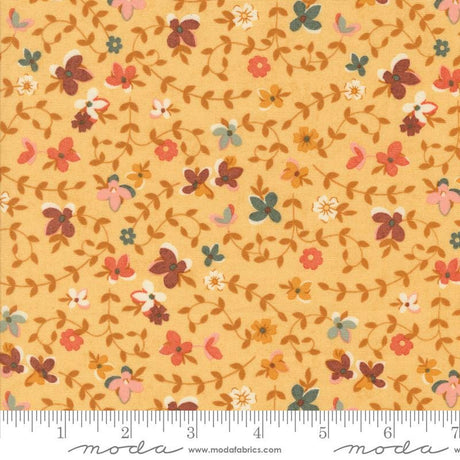 The image is a fabric with a floral pattern, featuring various colored flowers and leaves. The fabric appears to be a light yellow color, and the pattern is quite intricate and detailed.
