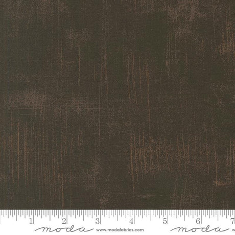 The image is a close-up of a textured fabric with a dark brown or black color.