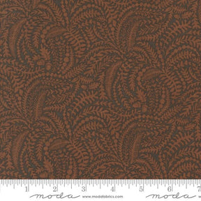 a close-up view of a fabric with a repeating pattern of brown leaves and branches, creating a textured and visually interesting design.