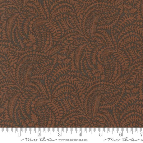 a close-up view of a fabric with a repeating pattern of brown leaves and branches, creating a textured and visually interesting design.