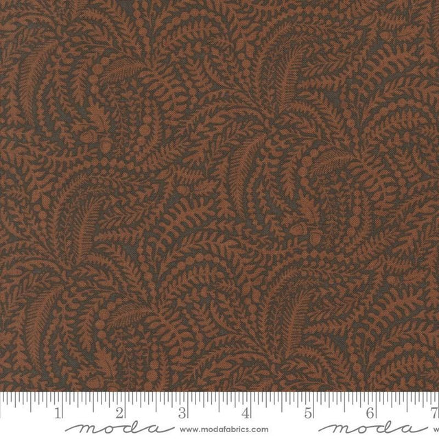 a close-up view of a fabric with a repeating pattern of brown leaves and branches, creating a textured and visually interesting design.