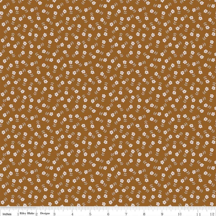 The image is a repeating pattern of small white flowers or dots against a brown background.