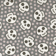 a repeating pattern of black and white skull faces against a gray background with small white flowers scattered throughout.