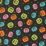 a repeating pattern of Halloween pumpkins in various colors and sizes against a dark background with stars.