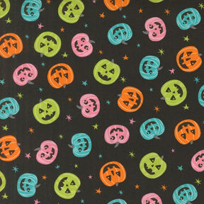 a repeating pattern of Halloween pumpkins in various colors and sizes against a dark background with stars.