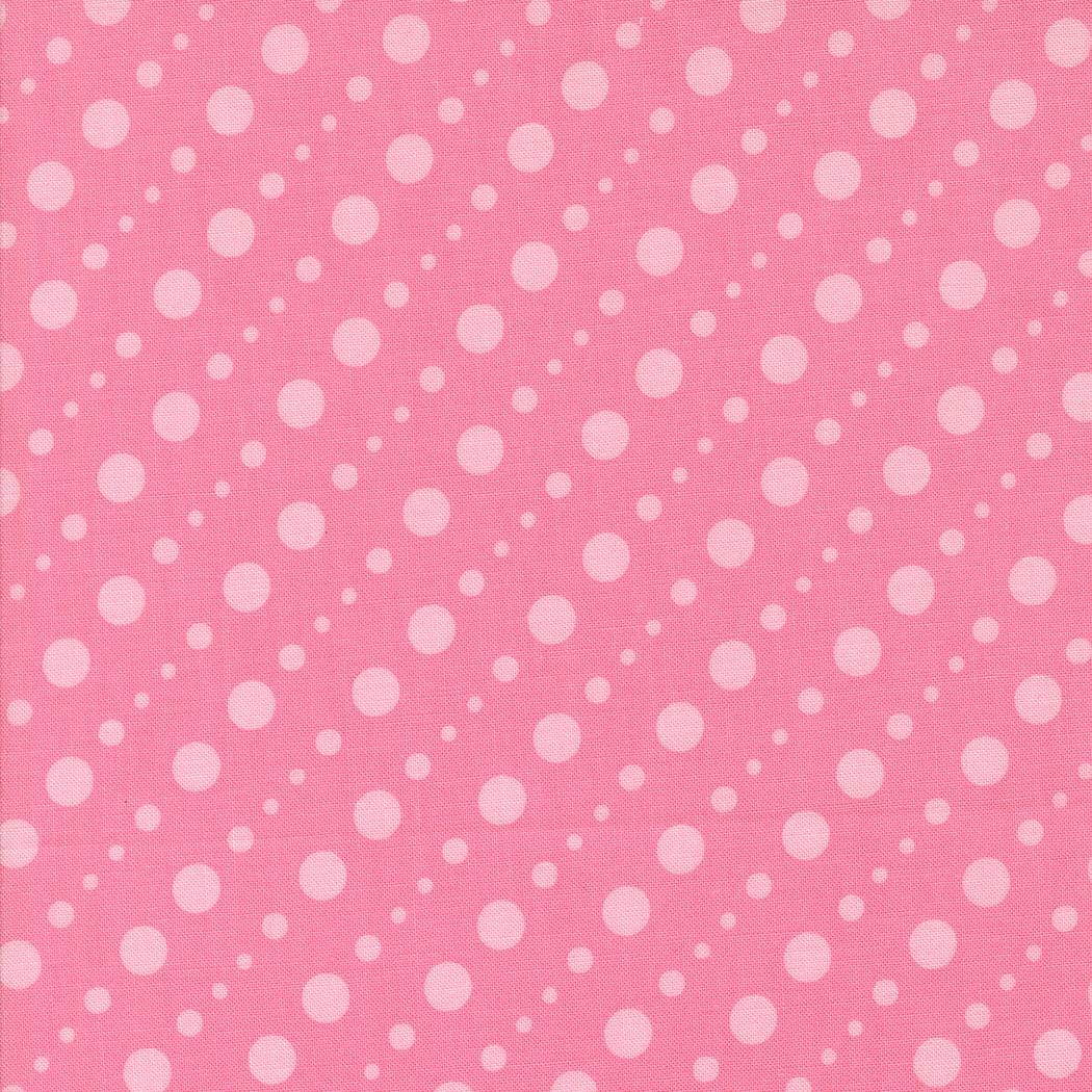 a pink background with white polka dots arranged diagonally across the frame.