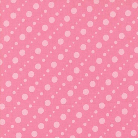 a pink background with white polka dots arranged diagonally across the frame.