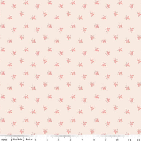 a repeating pattern of small pink flowers or leaves on a light peach background.