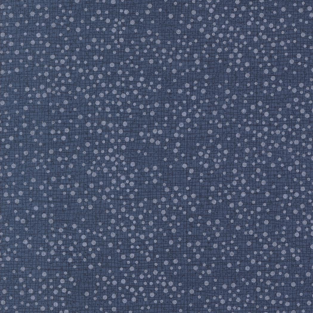 The image is a close-up of a dark blue fabric with numerous small white dots scattered across it, creating a speckled or speckled pattern.