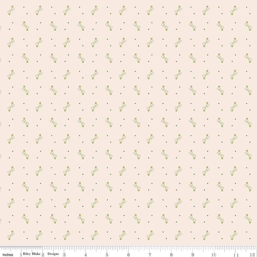 a repeating pattern of small green dots on a light pink background.