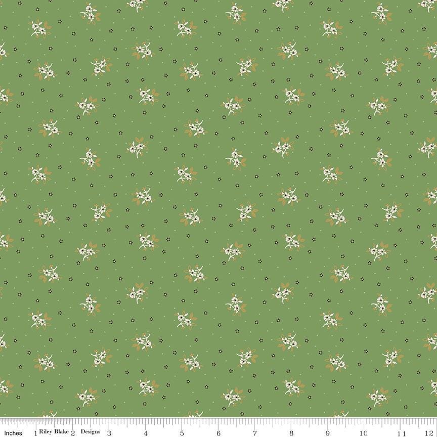 a repeating pattern of small white flowers against a green background.