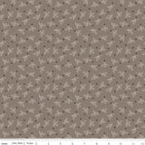 a repeating pattern of small white dots and leaf-like shapes on a brown background.