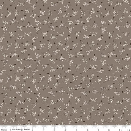 a repeating pattern of small white dots and leaf-like shapes on a brown background.