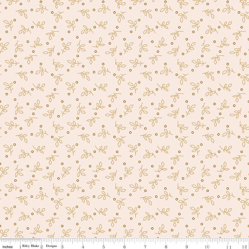 a repeating pattern of small orange leaves and dots on a light beige background.