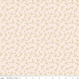 a repeating pattern of small orange leaves and dots on a light beige background.