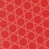a repeating pattern of red circles with white dots on a red background.