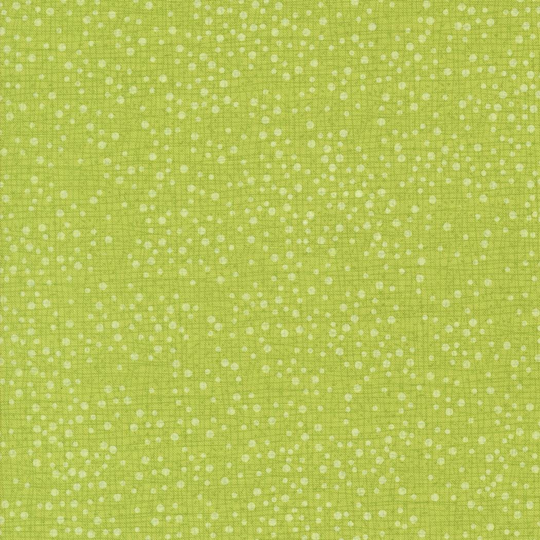 The image is a close-up of a fabric with a green color and small white dots or specks scattered across it.