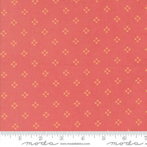 a red fabric with small yellow diamond-shaped patterns evenly distributed across it.