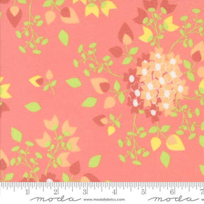 The image is a fabric with a floral pattern in shades of pink and green. The pattern features various flowers and leaves, creating a vibrant and colorful design.