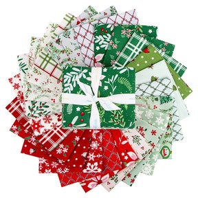 A circular arrangement of various fabric pieces with different patterns and colors, including red, green, white, and other festive designs, all tied together with a white ribbon bow.