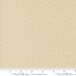 The image is a fabric sample with a light beige pattern, featuring small white dots or stars. The fabric is displayed on a ruler for scale, indicating its size.