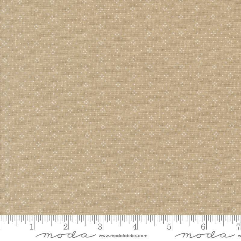 The image is a fabric with a beige pattern, featuring small white dots or stars arranged in a repeating design. The fabric appears to be a light-colored material, possibly a type of cotton or linen. The image does not contain any text or other discernible objects or actions.