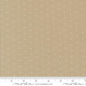 The image is a fabric with a beige pattern, featuring small white dots or stars arranged in a repeating design. The fabric appears to be a light-colored material, possibly a type of cotton or linen. The image does not contain any text or other discernible objects or actions.