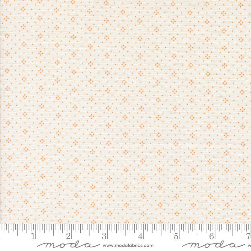 a fabric with a repeating pattern of small orange dots or stars on a light beige background. The fabric appears to be a fabric with a repeating pattern, possibly a fabric with a geometric or polka dot design. The image does not contain any text or other objects, and the focus is on the pattern and color of the fabric.