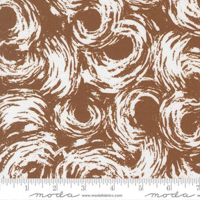 The image is a close-up of a brown and white patterned fabric, featuring a repeating swirl design.