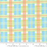 The image is a fabric with a plaid pattern in shades of blue, green, and orange. The fabric appears to be a soft, textured material suitable for clothing or home decor.