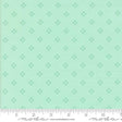 The image is a fabric with a repeating pattern of small green diamond shapes.