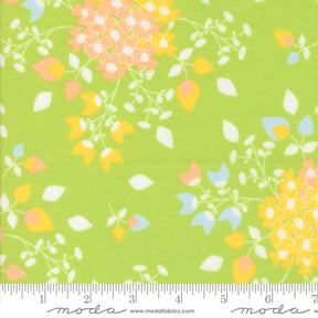 The image is a fabric with a floral pattern in shades of green and yellow. The pattern consists of various flowers and leaves, creating a vibrant and colorful design. The fabric appears to be a soft, textured material suitable for clothing or home decor.