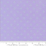 The image is a fabric with a purple background and a repeating pattern of small white stars or diamonds. The fabric appears to be a type of textile, possibly used for clothing or home decor.