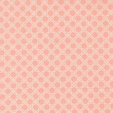 a repeating pattern of white flowers on a pink background.