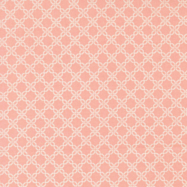 a repeating pattern of white flowers on a pink background.