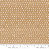 The image is a fabric with a repeating pattern of white crosses on a beige background.