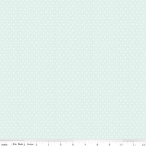 The image is a light blue fabric with small white polka dots covering the entire surface.