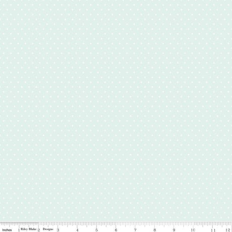 The image is a light blue fabric with small white polka dots covering the entire surface.