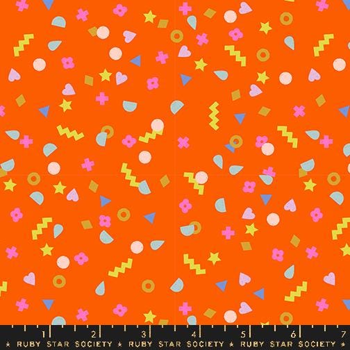 The image is a vibrant and playful collage of various colorful shapes and patterns, including stars, hearts, and geometric designs, all set against a bright orange background.