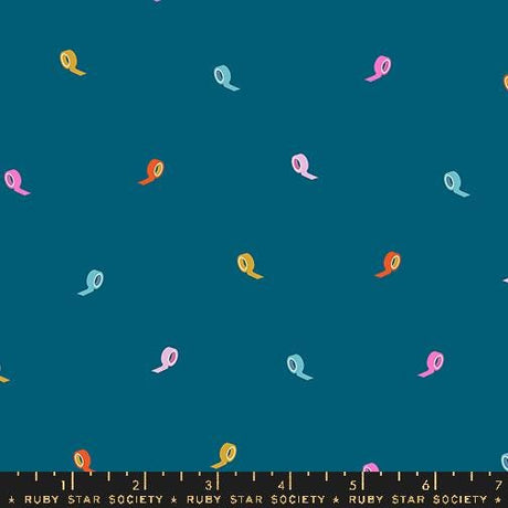 a pattern of colorful tape rolls against a dark blue background.