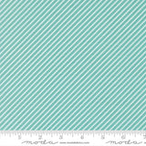 a fabric with a diagonal striped pattern in shades of green and white. The fabric appears to be a textile or material with a repeating diagonal pattern.
