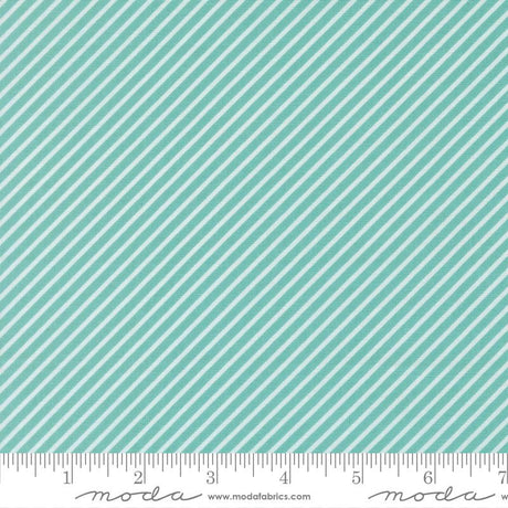 a fabric with a diagonal striped pattern in shades of green and white. The fabric appears to be a textile or material with a repeating diagonal pattern.