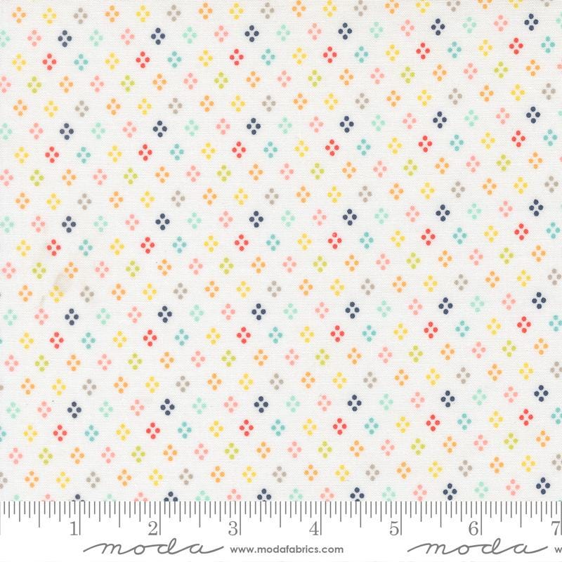 The image is a fabric with a repeating pattern of small dots in various colors, including shades of white, blue, green, yellow, and orange. The pattern is arranged in a grid-like fashion, creating a visually appealing and vibrant design.