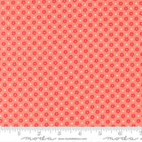 The image is a fabric with a repeating pattern of red flowers and white crosses. The pattern is composed of small dots and lines, creating a visually appealing and textured design.