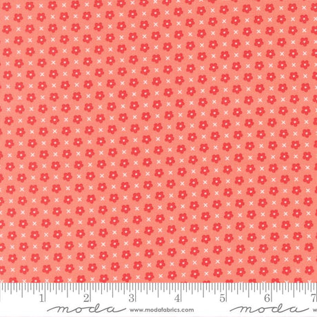 The image is a fabric with a repeating pattern of red flowers and white crosses. The pattern is composed of small dots and lines, creating a visually appealing and textured design.
