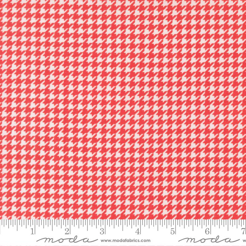 a red and white patterned fabric with a repeating geometric design.