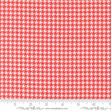 a red and white patterned fabric with a repeating geometric design.